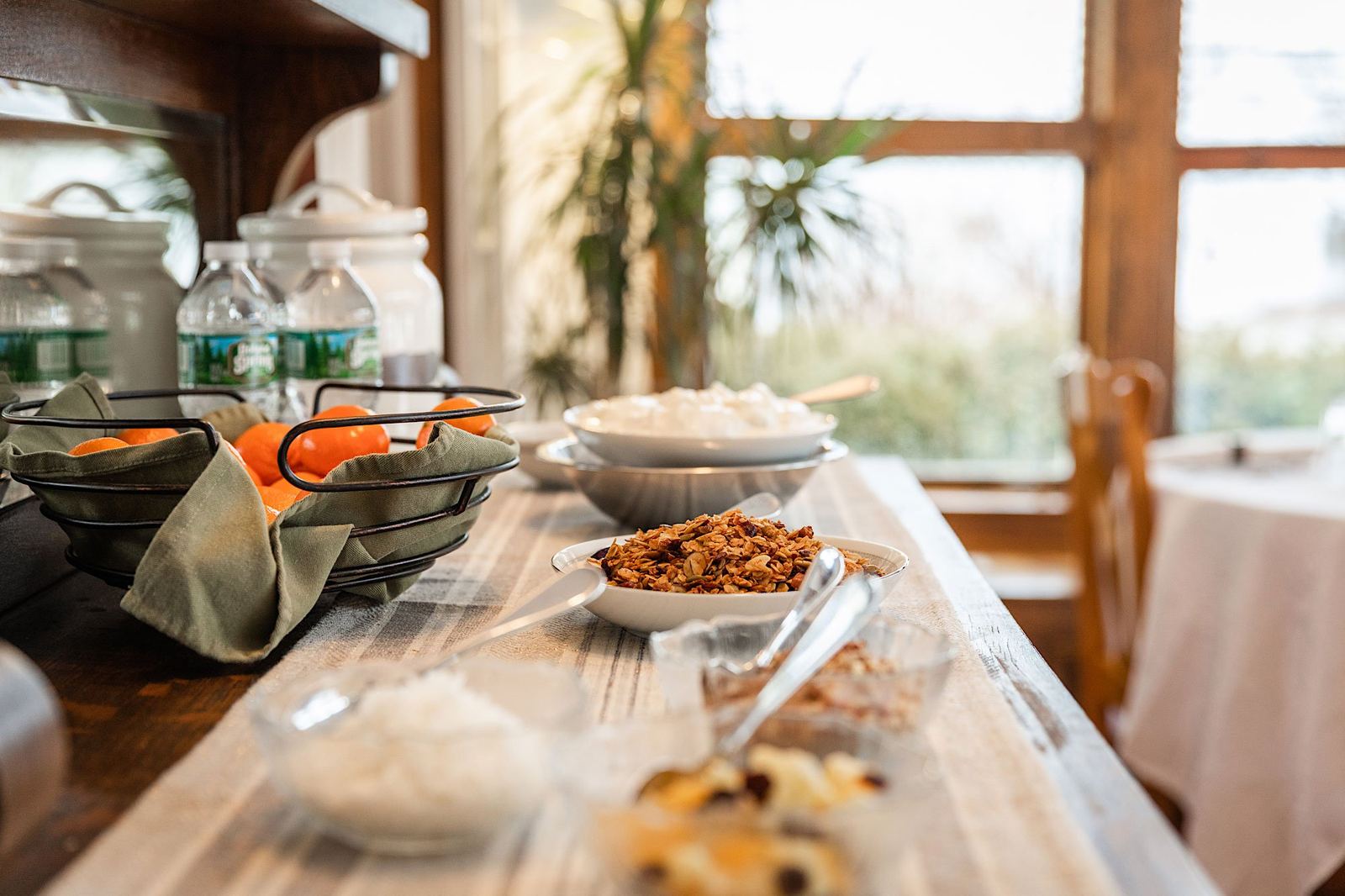 The breakfast bar: baskets of oranges, granola bowls, yogurt cups and bottled water