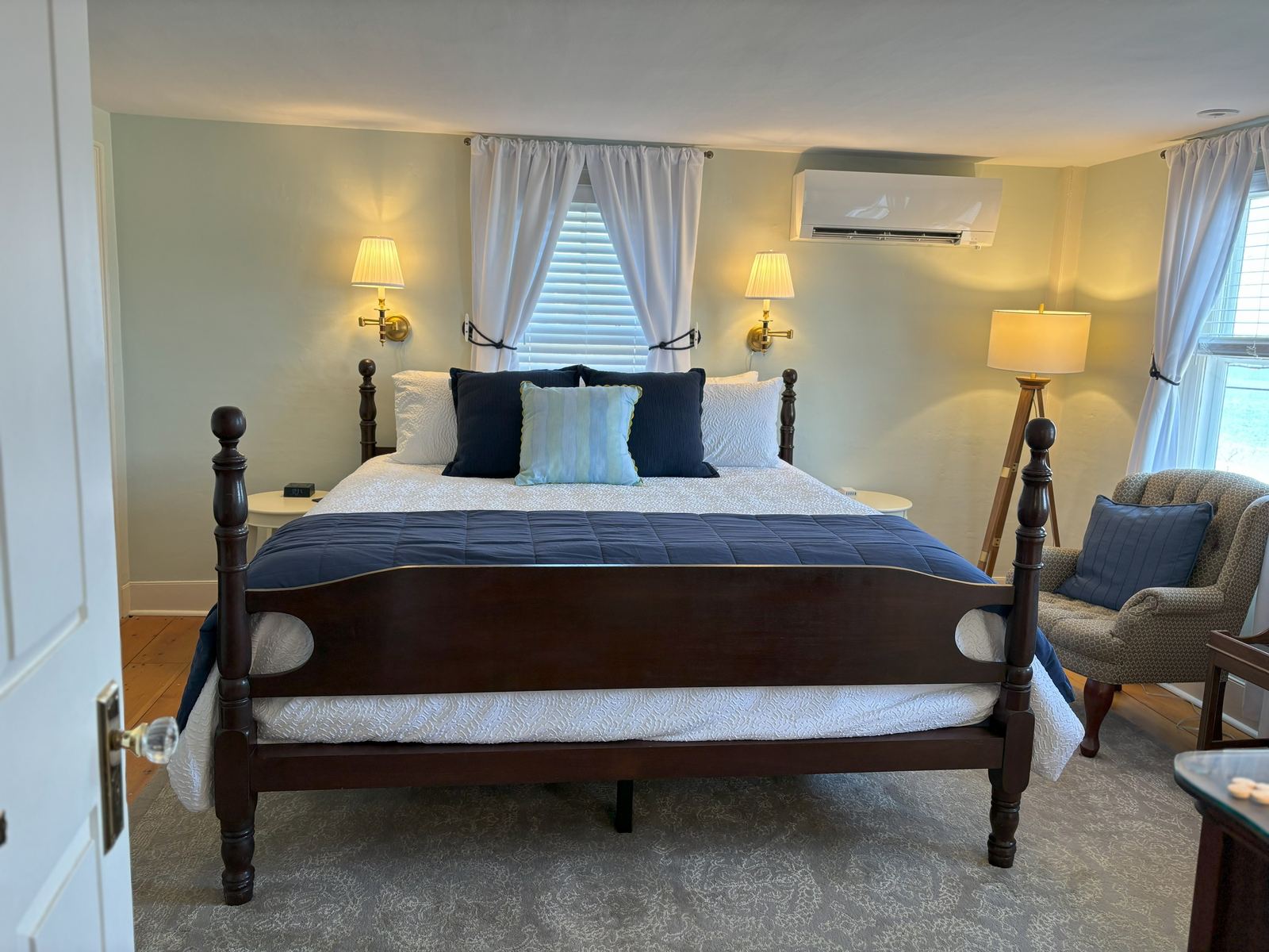 Harbormaster's Quarters: four-poster bed with a navy throw on sage-green walls